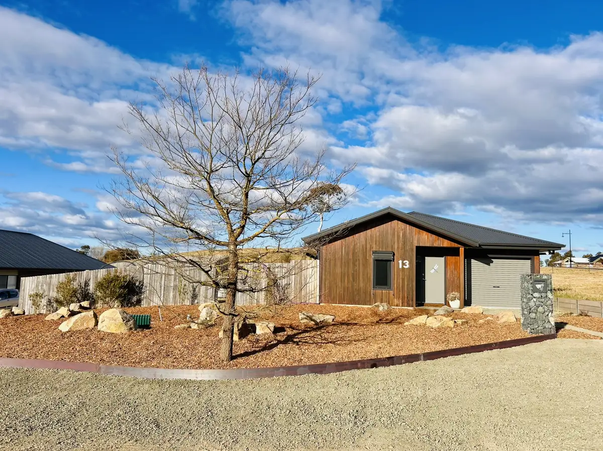 Rural home with gravel driveway and landscaped garden beds
